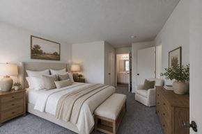 Southfield apartment for rent - A bedroom with a large bed, a chair, and a painting on the wall.