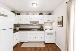 Riverdale apartment for rent - Compact kitchen with white appliances and wood countertops at Stratford Arms Apartments, Georgia