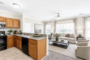 Cordova apartment for rent - A kitchen with wooden cabinets and a black dishwasher.