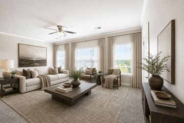 Cordova apartment for rent - A well-lit living room with a large painting on the wall and a ceiling fan.
