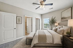 Cordova apartment for rent - A bedroom with a large bed and a ceiling fan.