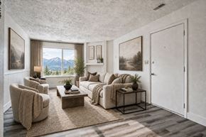 Layton apartment for rent - A living room with a large window overlooking a mountain range at The Morgan Apartments, Layton, UT, 84041