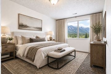Layton apartment for rent - A bedroom with a large bed and a painting on the wall.