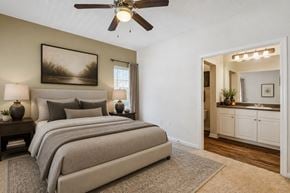 Atlanta apartment for rent - A bedroom with a large bed and a ceiling fan.