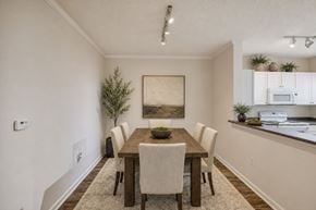 Atlanta apartment for rent - A dining room with a wooden table and chairs.