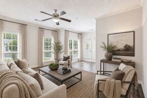 Atlanta apartment for rent - A living room with a couch, a coffee table, and a ceiling fan.
