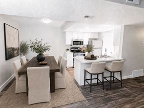 Midvale apartment for rent - A modern dining room with a wooden table and chairs at Creekview Apartments, Midvale, UT, 84047