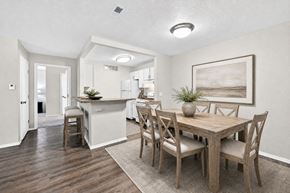 Saginaw apartment for rent - A dining room with a wooden table and chairs.