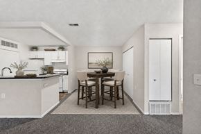 Saginaw apartment for rent - A kitchen with a dining table and chairs.