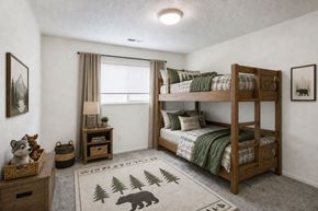 West Bountiful apartment for rent - A cozy bedroom with a bunk bed and a bear rug on the floor.