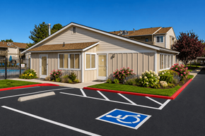 West Bountiful apartment for rent - A building with a parking lot in front of it, with a handicap parking space clearly marked.