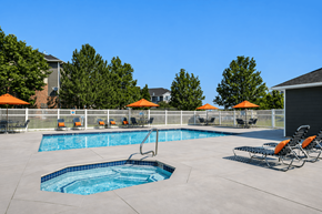 West Haven apartment for rent - A swimming pool with a slide and sun umbrellas at Haven Pointe Apartments, West Haven, Utah