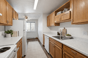 Vancouver townhouse for rent - A kitchen with wooden cabinets and a white refrigerator.