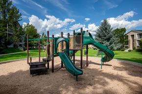 Heber City townhouse for rent - A playground with a green slide and a brown sandbox.