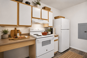 Sante Fe apartment for rent - A kitchen with white appliances and wooden cabinets.