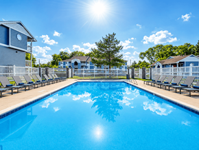 Midvale apartment for rent - A large swimming pool with sunlight reflecting on the water at Creekview Apartments, Midvale, UT