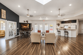 Sterling Heights apartment for rent - A living room with a fireplace and a dining table.