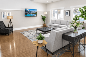Ogden apartment for rent - A living room with a grey couch, a black chair, and a coffee table.