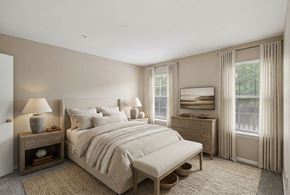 Grandview apartment for rent - A bedroom with a large bed, nightstand, and window.