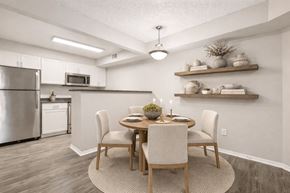 Arvada apartment for rent - A modern kitchen with a dining table set for two.