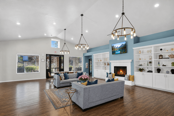 West Valley City apartment for rent - A living room with a grey couch and a fireplace.