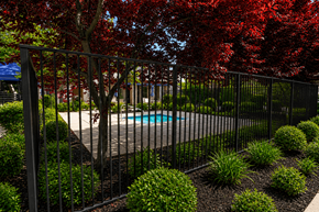 West Valley City apartment for rent - A pool surrounded by a black fence and red leaves.