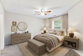 Newnan townhouse for rent - A bedroom with a bed, nightstand, and a dresser.