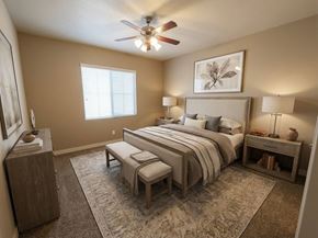 Salt Lake City apartment for rent - A bedroom with a large bed, a ceiling fan, and a rug on the floor.