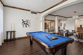Salt Lake City apartment for rent - A pool table is in the middle of a room with a blue cloth.