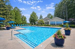 Stone Mountain apartment for rent - A swimming pool surrounded by trees and a house in the background.