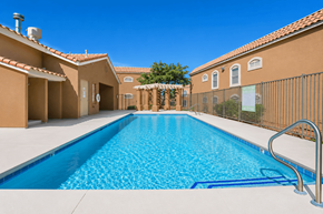 Henderson apartment for rent - A swimming pool in a residential area with a clear blue sky.