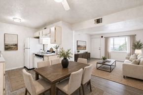 Henderson apartment for rent - A modern dining room with a wooden table and chairs.