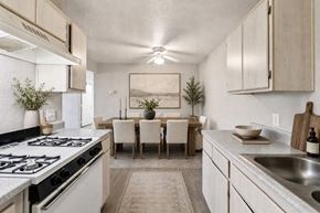 Henderson apartment for rent - A modern kitchen with a dining table set for four.