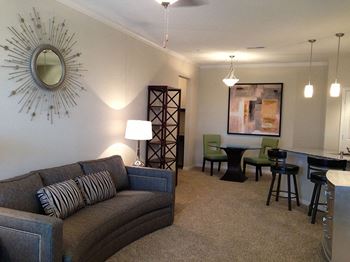 A living room with a couch and a dining room table