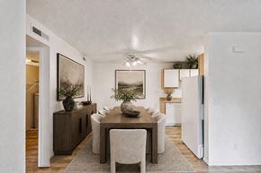 Logan apartment for rent - A dining room with a wooden table and chairs.