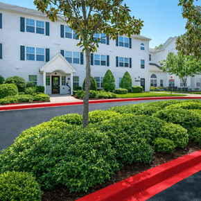 Marietta apartment for rent - A white building with a red stripe in front.