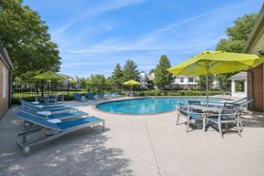 Greeley apartment for rent - A pool area with sun loungers and umbrellas.