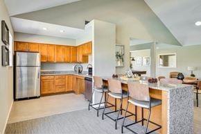 Jeffersonville apartment for rent - A kitchen with wooden cabinets and a stainless steel refrigerator.