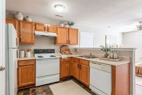Shelby apartment for rent - A kitchen with wooden cabinets and white appliances.