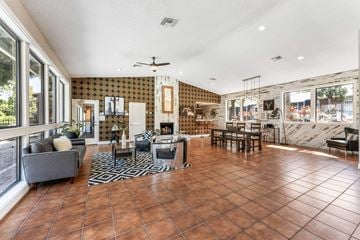 Daytona Beach apartment for rent - A living room with a grey couch and a black and white rug.