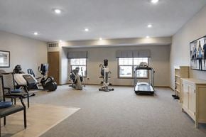 Andover apartment for rent - A spacious room with exercise equipment and a bench.