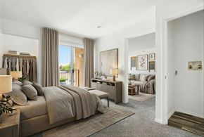 Rio Rancho apartment for rent - A bedroom with a large bed and a view of the outdoors through the window.