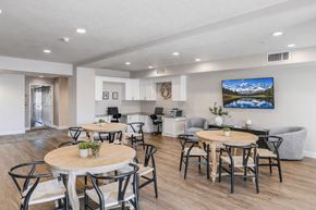 South Jordan apartment for rent - A modern dining room with a wooden table surrounded by chairs.