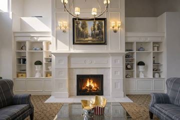 South Jordan apartment for rent - A living room with a fireplace and a painting on the wall.