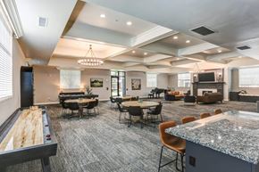 South Jordan apartment for rent - A spacious room with a pool table and a bar area.