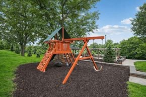 Vadnais Heights apartment for rent - A playground with a swing set and a green roof at Aster Meadow, Vadnais Heights, MN, 55127