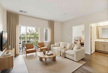 Vadnais Heights apartment for rent - A living room with a white couch and a television.