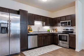 Allen apartment for rent - A kitchen with a refrigerator, oven, and microwave.