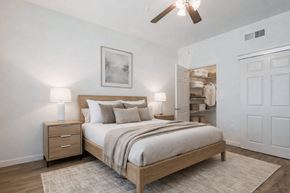Allen apartment for rent - A bedroom with a bed, nightstand, and a ceiling fan.