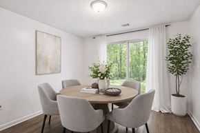 College Park townhouse for rent - A dining room with a round table and grey chairs.